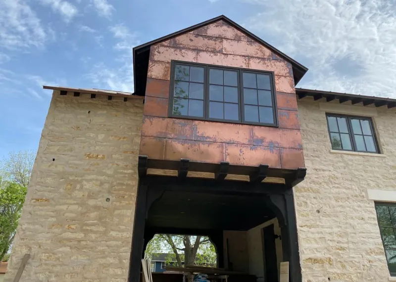 Copper metal panel facade on a stone building for Metal Roof Coating in Banning